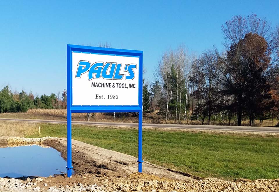 road side sign to Paul's Machine " Tool, Inc. of Warrens, WI